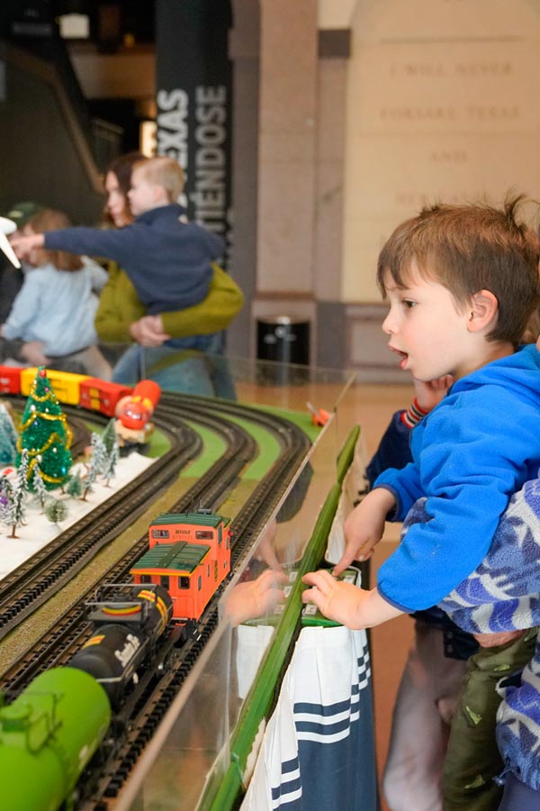 a child looking at a train display